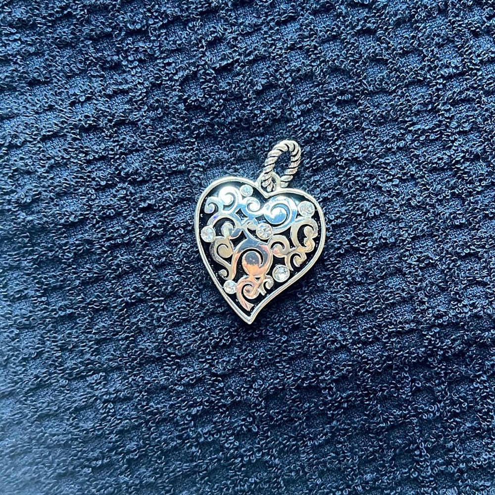 Silver tone heart pendant.